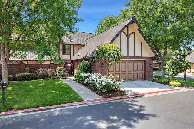 2827 W Compton Ct, Fresno, CA 93711 - tudor house featuring driveway, a front yard, a garage, brick siding, and stucco siding