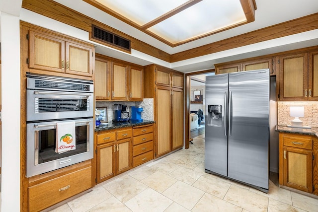 2827 W Compton Ct, Fresno, CA 93711 - kitchen featuring brown cabinetry, backsplash, visible vents, appliances with stainless steel finishes, and dark stone counters