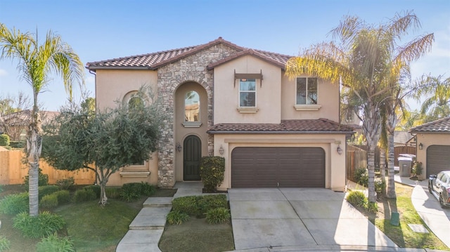 11340 N Via Verona Way, Fresno, CA 93730 - mediterranean / spanish-style house featuring fence, a garage, stucco siding, a tiled roof, and driveway