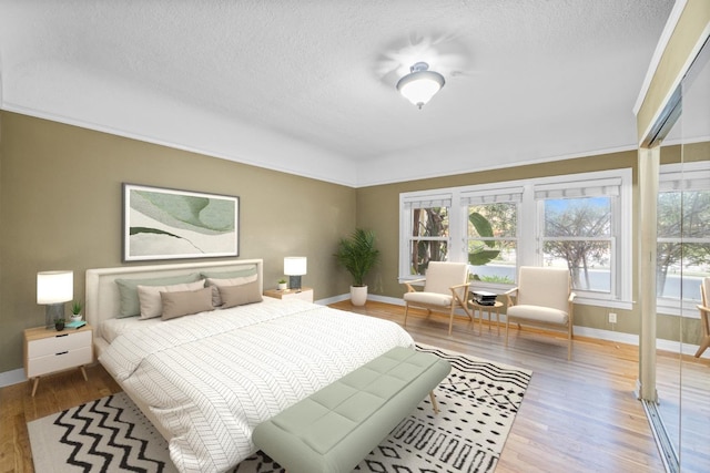 2436 N Van Ness Blvd, Fresno, CA 93704 - bedroom featuring baseboards, a textured ceiling, and wood finished floors