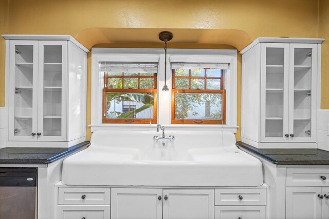 2436 N Van Ness Blvd, Fresno, CA 93704 - kitchen featuring white cabinetry, a healthy amount of sunlight, glass insert cabinets, and dishwasher