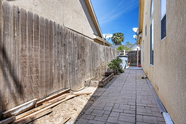 2955 E Christopher, Fresno, CA 93720 - view of property exterior with fence, a garden, a patio area, and stucco siding