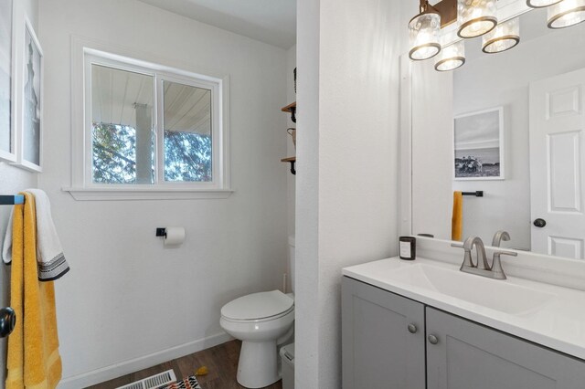 43299 Ranger Circle Dr, Coarsegold, CA 93614 - half bath with visible vents, wood finished floors, vanity, baseboards, and toilet