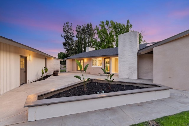 2044 W San Bruno Ave, Fresno, CA 93711 - view of front facade with a chimney and a patio area