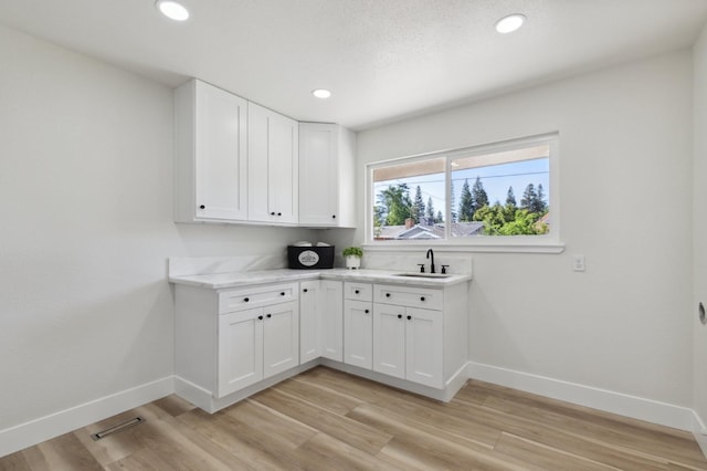 2044 W San Bruno Ave, Fresno, CA 93711 - washroom featuring visible vents, a sink, baseboards, light wood finished floors, and recessed lighting