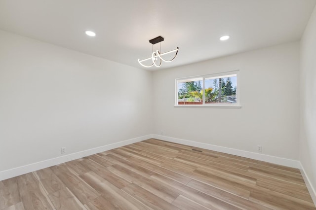 2044 W San Bruno Ave, Fresno, CA 93711 - unfurnished room featuring an inviting chandelier, recessed lighting, baseboards, and light wood-type flooring