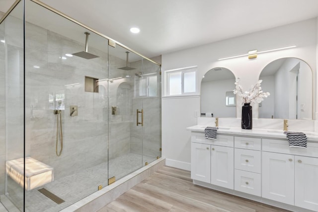 2044 W San Bruno Ave, Fresno, CA 93711 - full bathroom featuring a sink, double vanity, baseboards, wood finished floors, and a stall shower