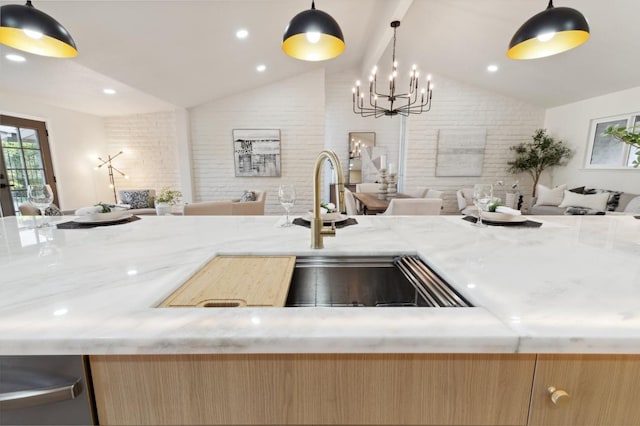 2044 W San Bruno Ave, Fresno, CA 93711 - kitchen featuring open floor plan, vaulted ceiling, light stone counters, and an inviting chandelier