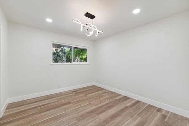 2044 W San Bruno Ave, Fresno, CA 93711 - empty room with recessed lighting, baseboards, a notable chandelier, and light wood-type flooring