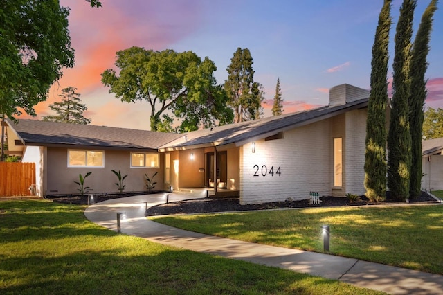 2044 W San Bruno Ave, Fresno, CA 93711 - ranch-style home with brick siding, a front lawn, fence, and a chimney