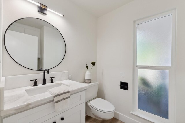 2044 W San Bruno Ave, Fresno, CA 93711 - half bath with toilet, wood finished floors, and vanity
