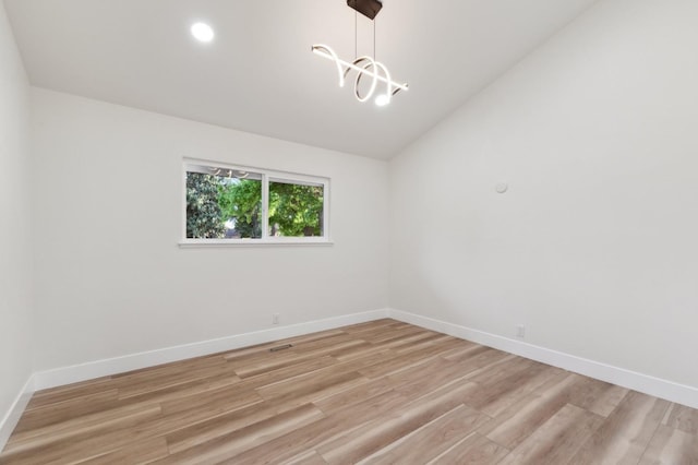 2044 W San Bruno Ave, Fresno, CA 93711 - unfurnished room with baseboards, a notable chandelier, light wood-type flooring, and lofted ceiling