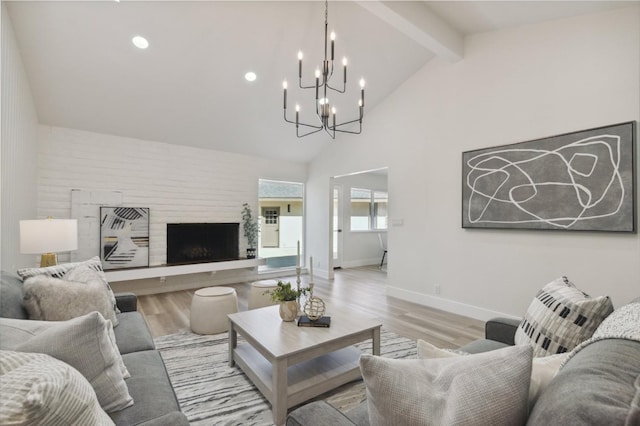 2044 W San Bruno Ave, Fresno, CA 93711 - living room with baseboards, light wood finished floors, a notable chandelier, and beamed ceiling