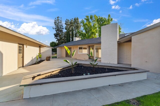 2044 W San Bruno Ave, Fresno, CA 93711 - exterior space featuring a patio and a chimney