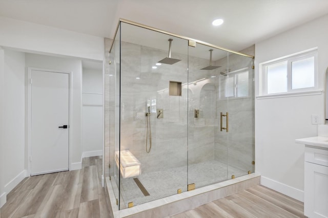 2044 W San Bruno Ave, Fresno, CA 93711 - bathroom featuring a stall shower, wood finished floors, vanity, baseboards, and recessed lighting