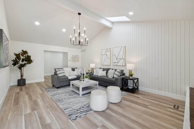 2044 W San Bruno Ave, Fresno, CA 93711 - living room featuring baseboards, lofted ceiling with skylight, light wood-style flooring, and a notable chandelier