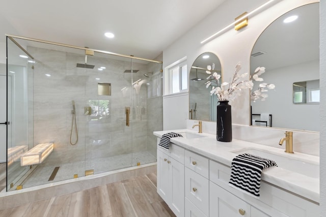 2044 W San Bruno Ave, Fresno, CA 93711 - bathroom featuring double vanity, visible vents, a stall shower, wood finished floors, and a sink