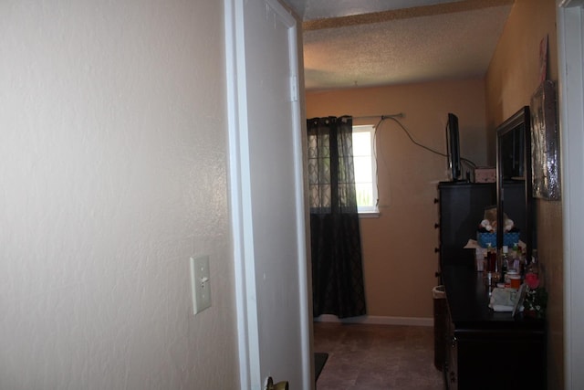 1939 S Sierra Vista Ave, Fresno, CA 93702 - hallway with baseboards and a textured ceiling