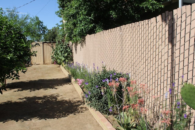 1939 S Sierra Vista Ave, Fresno, CA 93702 - view of yard with an outbuilding, fence, and a storage unit