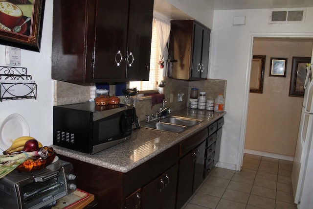 1939 S Sierra Vista Ave, Fresno, CA 93702 - kitchen with a sink, black microwave, visible vents, and tasteful backsplash
