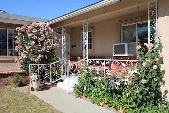1939 S Sierra Vista Ave, Fresno, CA 93702 - view of exterior entry featuring a porch, stucco siding, and cooling unit