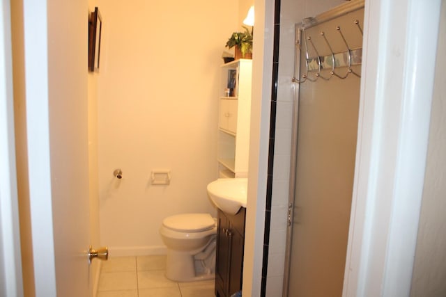 1939 S Sierra Vista Ave, Fresno, CA 93702 - full bathroom featuring a stall shower, tile patterned flooring, toilet, and vanity