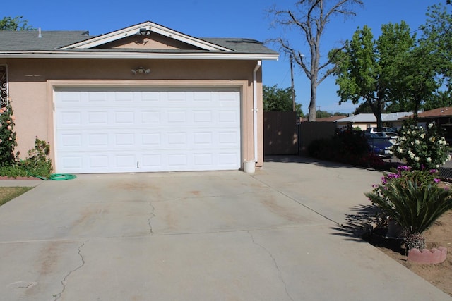1939 S Sierra Vista Ave, Fresno, CA 93702 - garage with concrete driveway and fence