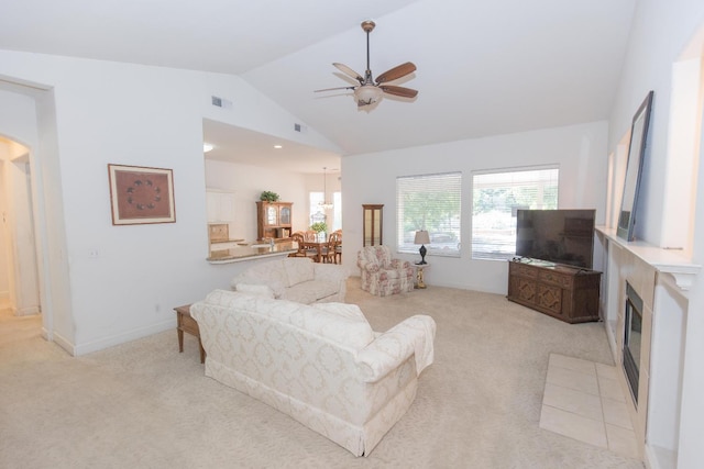 living room featuring light colored carpet, vaulted ceiling, visible vents, and ceiling fan