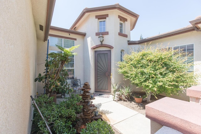 property entrance with stucco siding