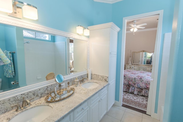 ensuite bathroom with ornamental molding, tile patterned flooring, ensuite bath, and a sink
