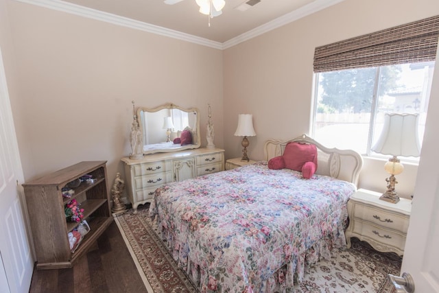 bedroom with a ceiling fan, crown molding, and wood finished floors