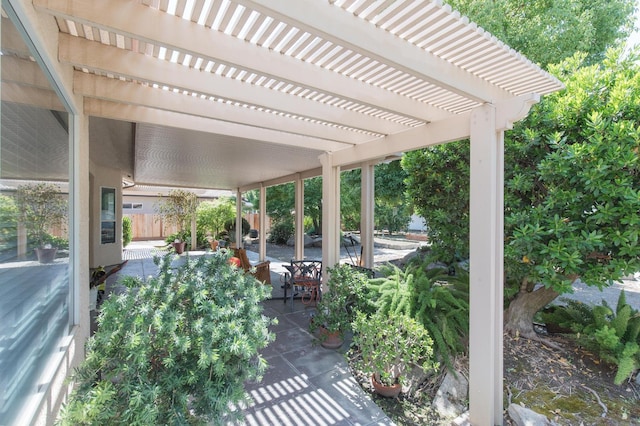 view of patio with a pergola and fence
