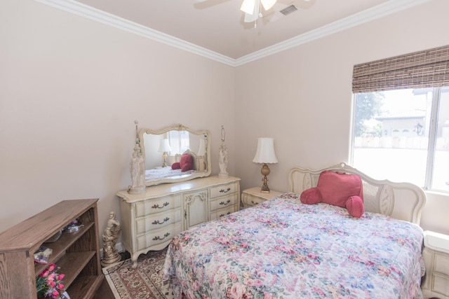 bedroom with ornamental molding, a ceiling fan, and visible vents