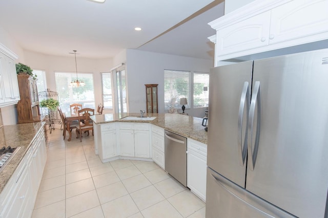 kitchen featuring light tile patterned floors, a notable chandelier, white cabinetry, and appliances with stainless steel finishes