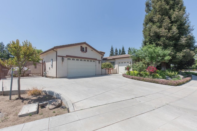 ranch-style home with an attached garage, stucco siding, and driveway