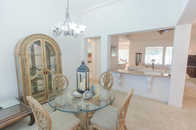 dining area featuring an inviting chandelier, baseboards, and carpet floors