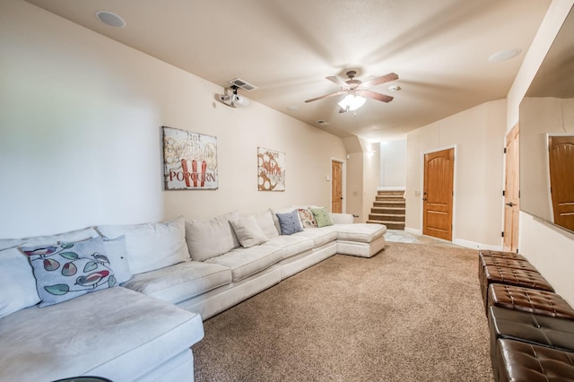 living room with ceiling fan, stairs, carpet, and visible vents