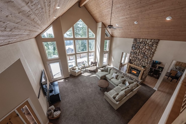 living room featuring wooden ceiling, a fireplace, a ceiling fan, and high vaulted ceiling