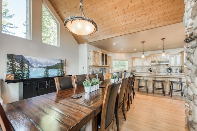 dining space with recessed lighting, a wealth of natural light, high vaulted ceiling, and light wood-style floors