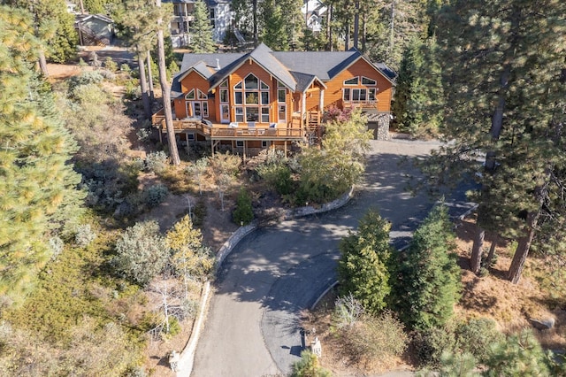 view of front facade featuring driveway and a deck