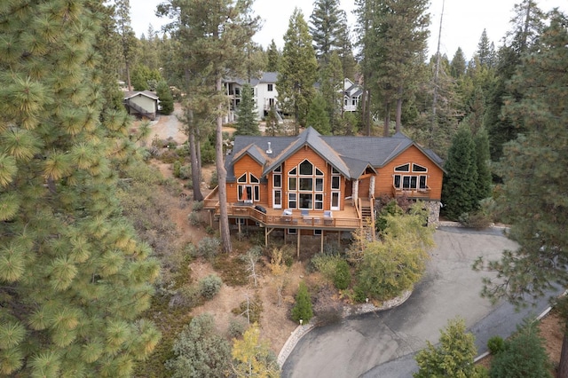 rear view of property with stairs and driveway