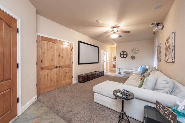 living area featuring carpet flooring, visible vents, baseboards, and ceiling fan