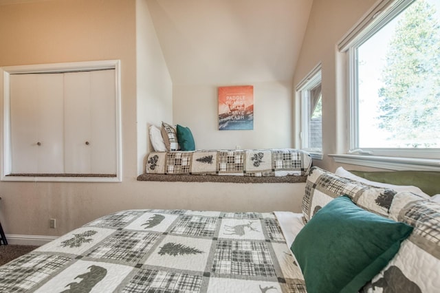 bedroom featuring vaulted ceiling and baseboards