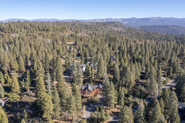 aerial view featuring a mountain view and a view of trees