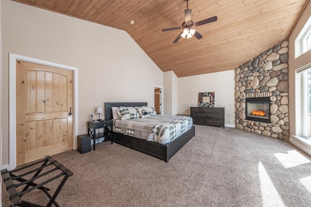 bedroom with carpet, high vaulted ceiling, a ceiling fan, wood ceiling, and a stone fireplace