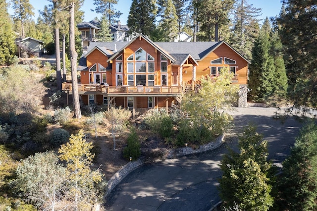 view of front of house featuring aphalt driveway and a deck