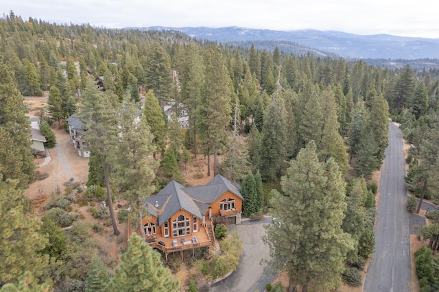aerial view with a wooded view and a mountain view