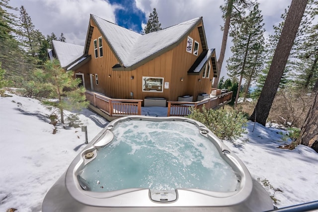 exterior space featuring a hot tub and a deck