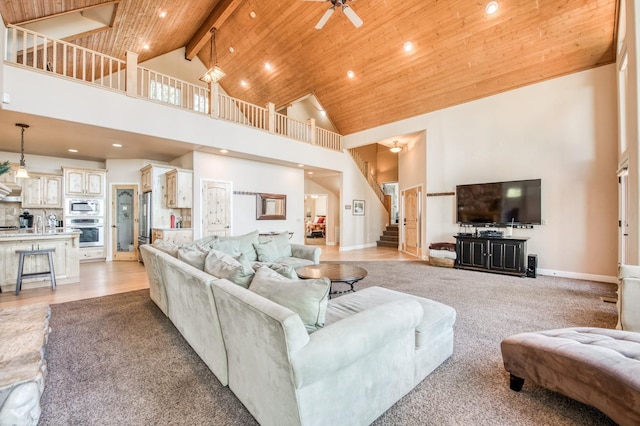 living area with recessed lighting, wooden ceiling, ceiling fan, high vaulted ceiling, and stairway