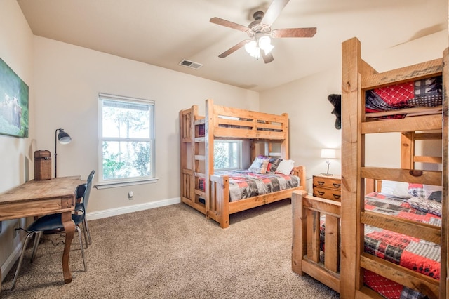 bedroom with carpet flooring, visible vents, baseboards, and ceiling fan